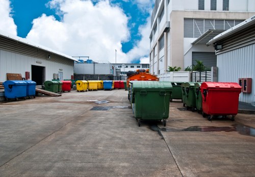 Workers wearing PPE and practicing safe lifting during waste removal