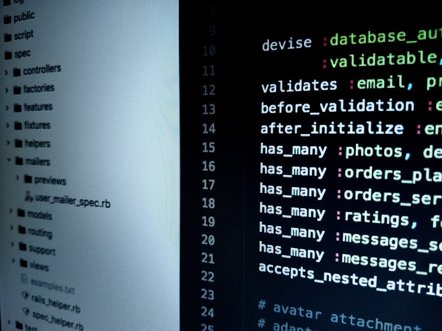 A close-up photograph of a computer screen displaying lines of source code written in HTML and CSS, featuring tags and attributes in various colors such as blue, red, yellow, and green, set against a 